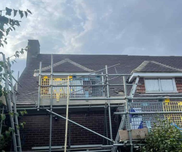 This is a photo of a roof with two dormers that is having some damaged tiles replaced. Works carried out by ATY Roofing Mexborough