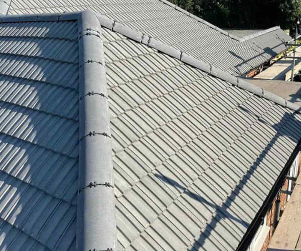 This is a photo of a completed new hip roof installed by ATY Roofing Mexborough. The photo shows a side elevation, and grey tiles have been used.This is a photo of a completed new hip roof installed by ATY Roofing Mexborough. The photo shows a side elevation, and grey tiles have been used.