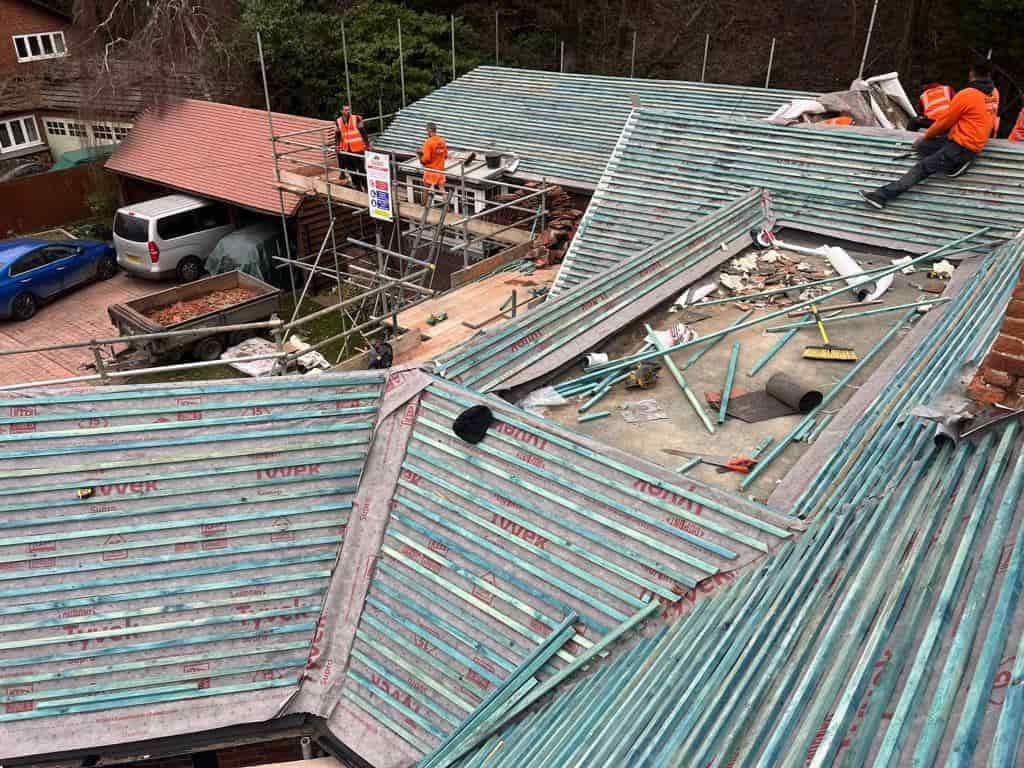 This is a photo of a large re-roof being carried out by ATY Roofing Mexborough, there are multiple sections of pitched roofs adjoining to a central flat roof